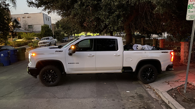 A side view of the Chevrolet Silverado 2500 HD Trail Boss with a bed full of stuff