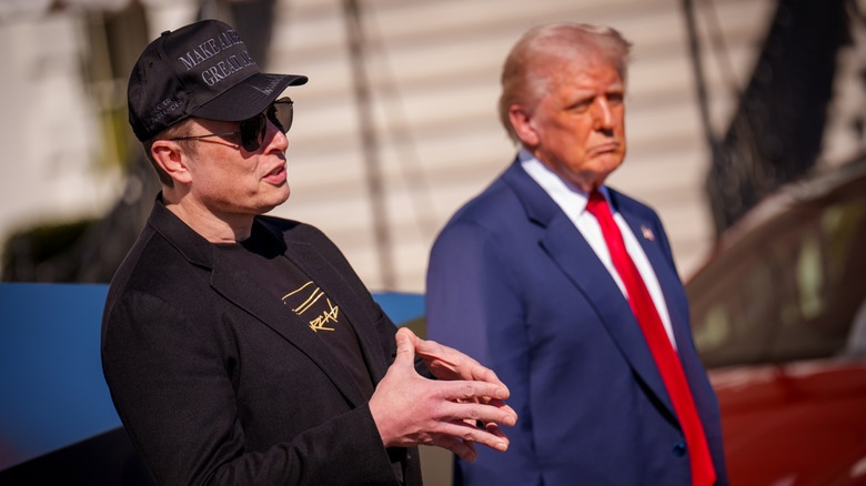 President Donald Trump listens as White House Senior Advisor, Tesla and SpaceX CEO Elon Musk, speaks next to a Tesla Cyber Truck and a Model S on the South Lawn of the White House on March 11, 2025 in Washington, DC.