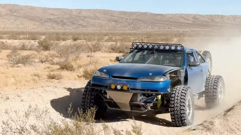 A Nissan 240SX on offroad tires in the desert