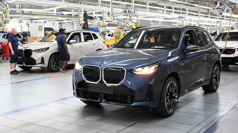 A blue BMW X3 rolling off the assembly line