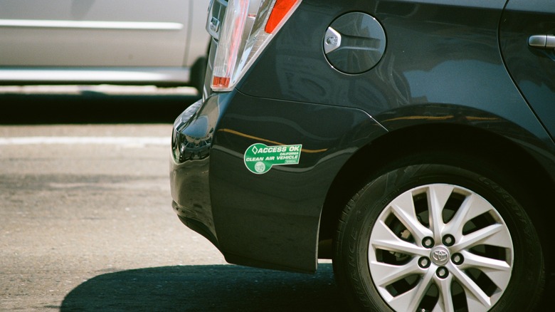 Closeup of Access Ok, California Clean Air Vehicle decal on the bumper of a black Toyota automobile, indicating that the automobile may drive in carpool lanes, Silicon Valley, San Jose, California, August 17, 2017