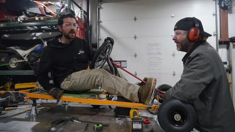 The guys from Cars and Cameras in the middle of building a go-kart.