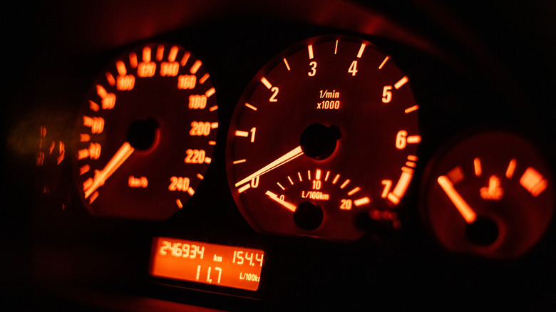 A car's instrument panel illuminated with orange backlight