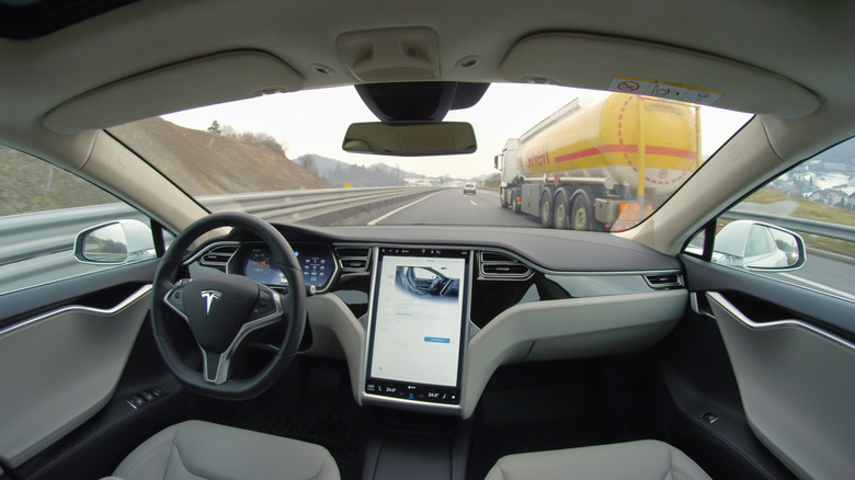 A photo of a Tesla running with Autopilot.