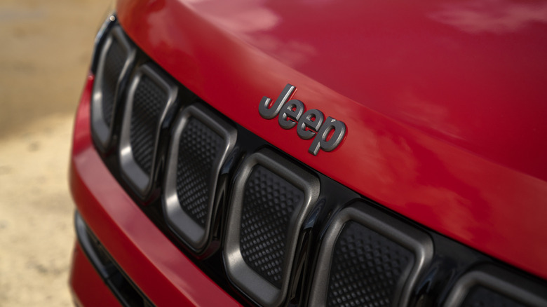 A photo of the Jeep logo on a car.