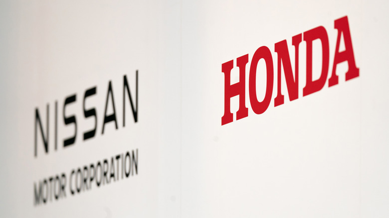 A photo of the logos for Honda and Nissan.