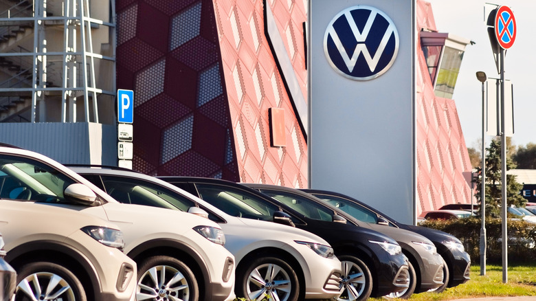 A photo of cars for sale at a VW dealer.