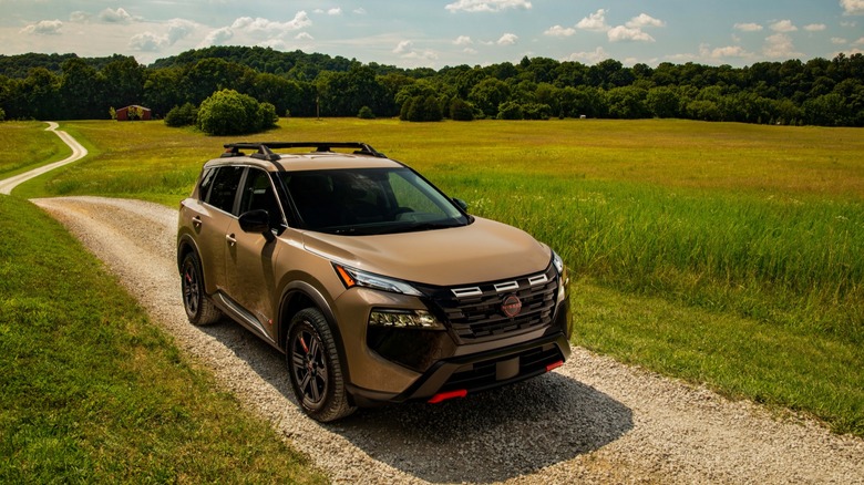 A photo of a beige Nissan Rogue SUV.