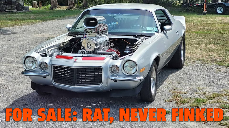 A silver Chevy Camaro with no hood and a blower out the top, captioned FOR SALE: RAT, NEVER FINKED