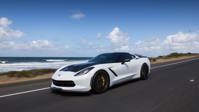 A C7 Corvette driving along the shore.