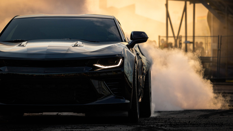 A new Chevy Camaro doing a sick burnout.