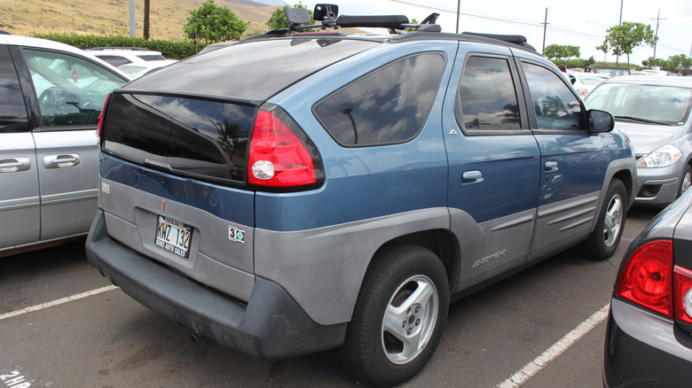 A blue Pontiac Aztek from the rear with faded bumpers