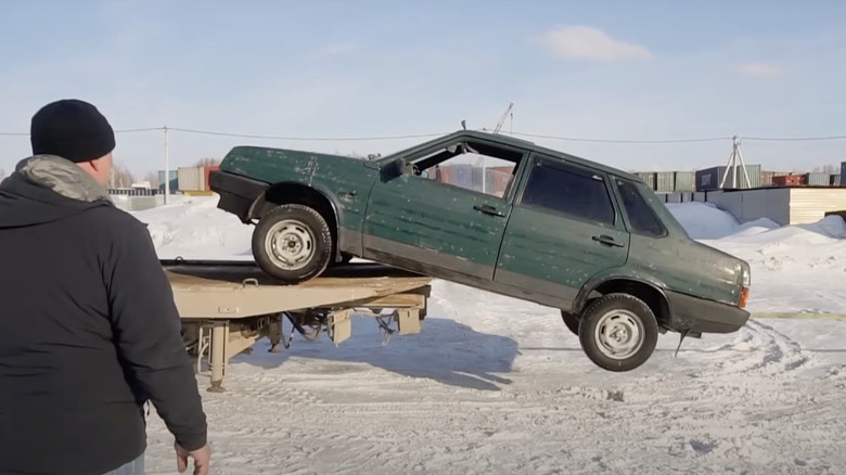 A green Lada, a yellow COE flatbed, and one Russian smart aleck.