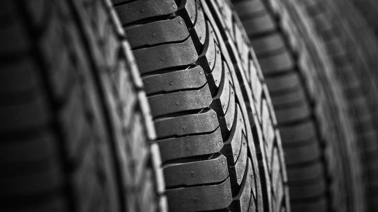 Closeup of a new car tire showing vent spews.