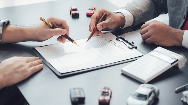 Signing a contract at a dealership