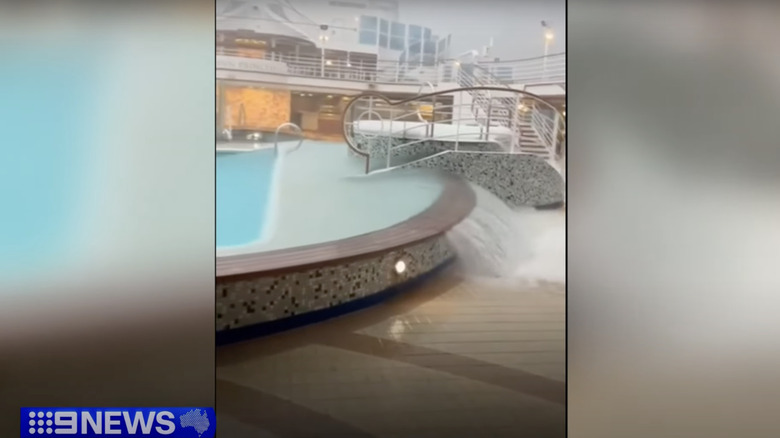 Water pouring out of a swimming pool on the deck of a cruise ship