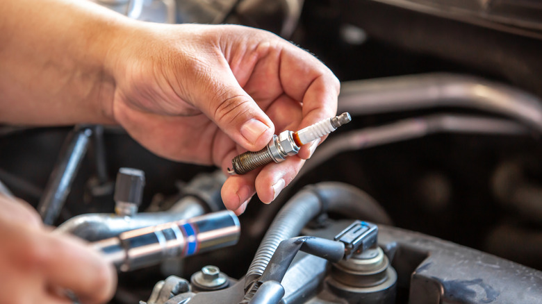 A mechanic inspecting a spark plug