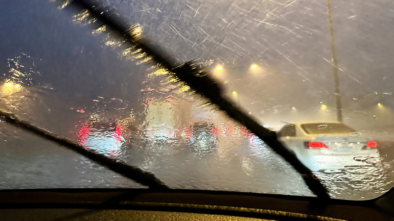 Windshield wipers working hard on a stormy night.