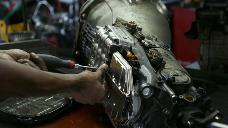 A mechanic disassembling a transmission