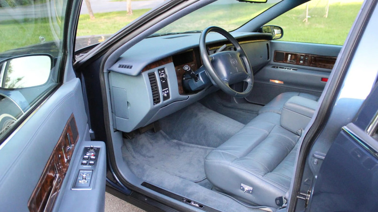 The blue dashboard and interior of a 1996 Cadillac Fleetwood