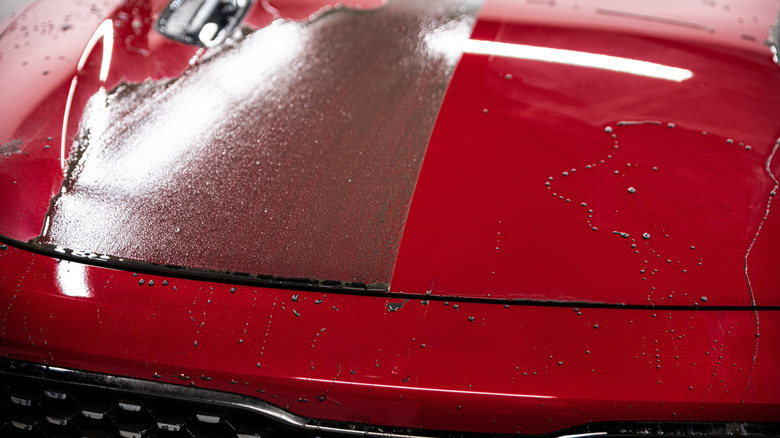 The effect shown after applying a ceramic coating on a red car