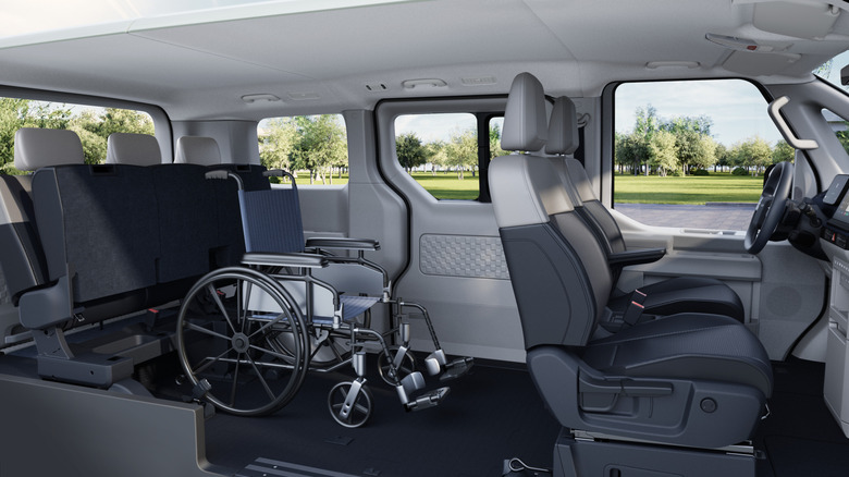 The interior of a Kia PV5 with a wheelchair placed in the second row.