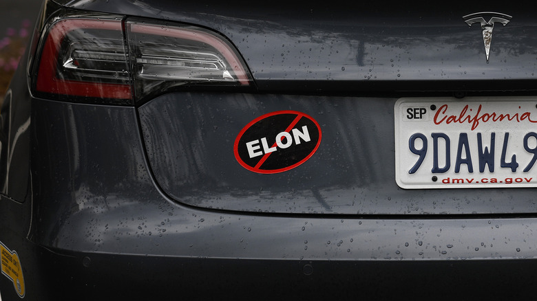 A bumper sticker protesting Tesla CEO Elon Musk is shown on a Tesla car on March 12, 2025 in Corte Madera, California.