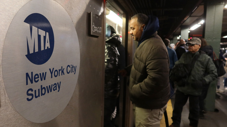 People board a 2-line train at the Times Square - 42nd Street subway station on February 18 2025, in New York City.