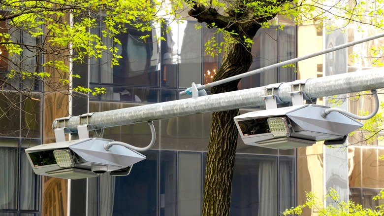 New York's congestion pricing program uses overhead booms with digital scanners that read license plates and bill drivers entering Manhattan below 60th Street.