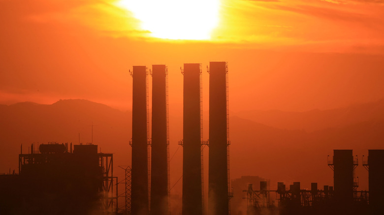 Foggy factory with the sun behind it