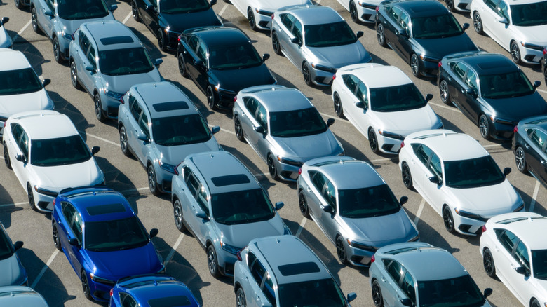 A photo of new Honda cars lined up outside a factory.