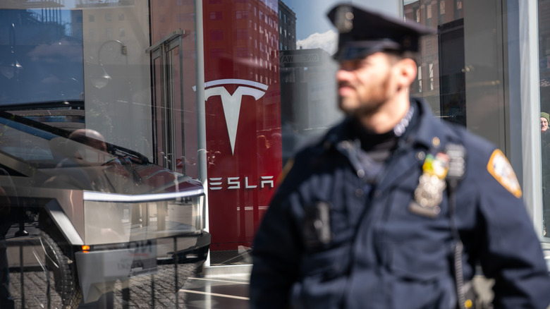 Police officer protects Tesla dealership