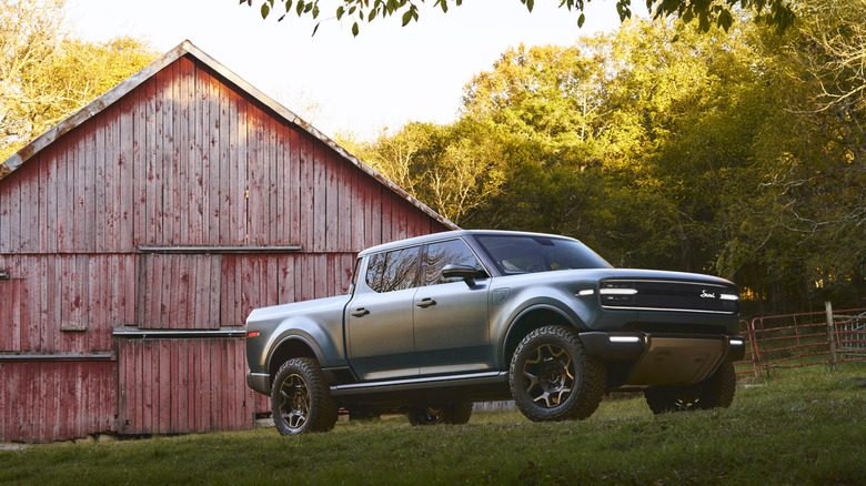 A photo of a Scout electric pickup on a farm.