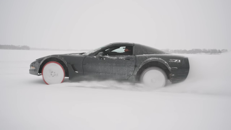 A photo of a Corvette driving on ice.