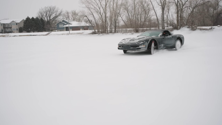 A photo of a Corvette driving on ice.