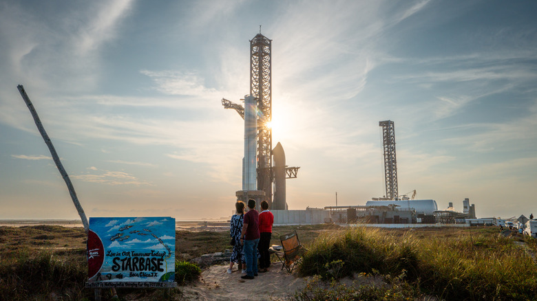 People watch SpaceX Starship Flight 8 as it is stationed near Orbital Launch Pad A ahead of launch at Boca Chica beach on March 03, 2025 in Boca Chica Beach, Texas.