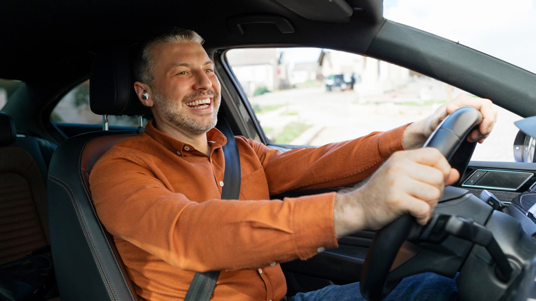 Man wears headphones while driving