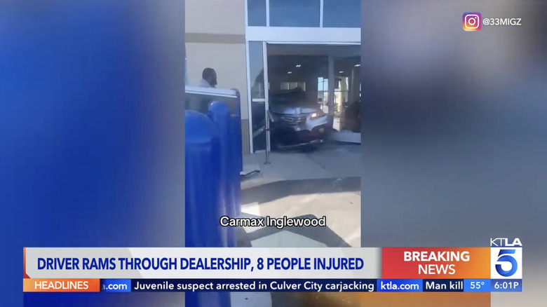 Screenshot from a news report of a Subaru Outback crashing into CarMax