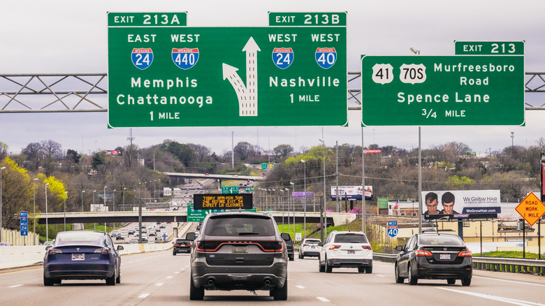 Daytime traffic on Interstate 40 as it approaches Nashville, with signs for upcoming freeway exits.