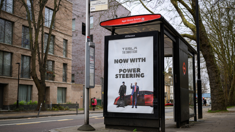 A photo of an anti-Tesla ad on a London bus stop.