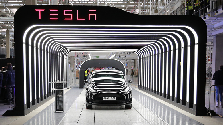 A photo of a Tesla car leaving the production line.