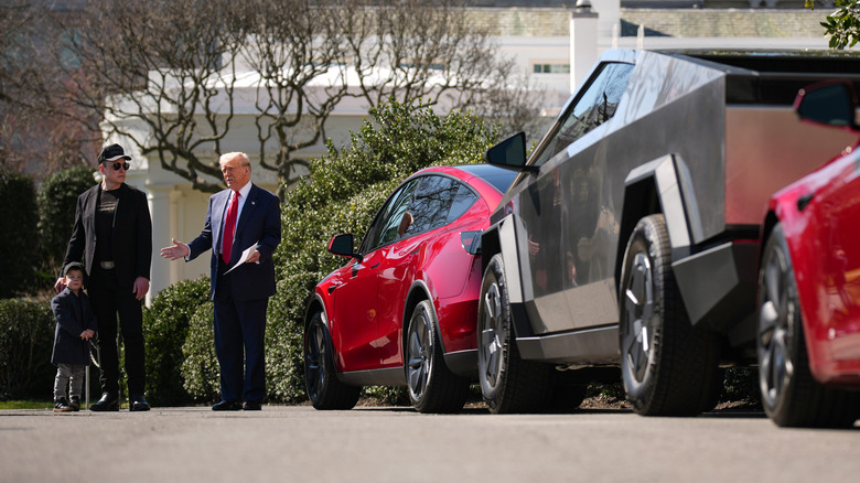 U.S. President Donald Trump, joined by White House Senior Advisor, Tesla and SpaceX CEO Elon Musk and his son X Æ A-Xii, delivers remarks next to a Tesla Model Y, a Cyber Truck and two Model S vehicles on the South Lawn of the White House on March 11, 2025 in Washington, DC.