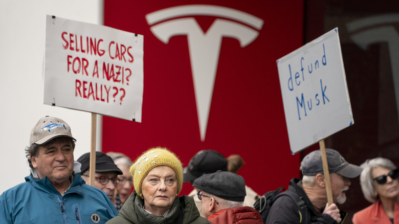 Protesters outside a Tesla store