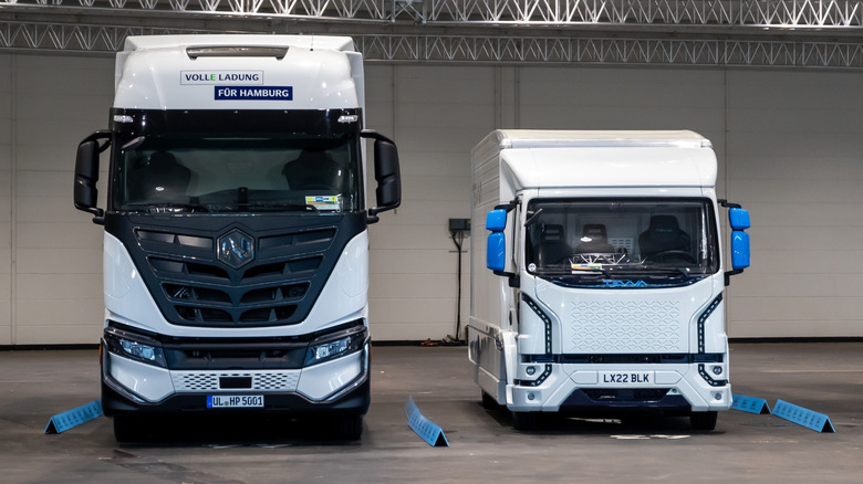 A photo of two Nikola trucks at an auto show.