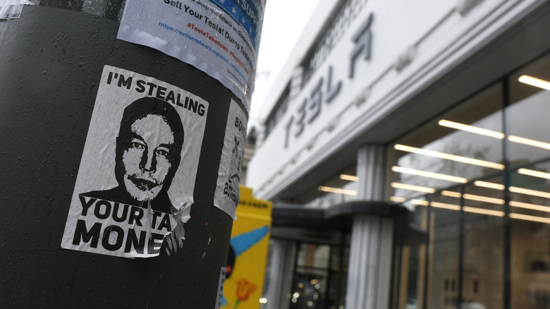 A flyer protesting Tesla CEO Elon Musk is shown on a utility pole outside a Tesla dealership on March 12, 2025 in San Francisco, California.