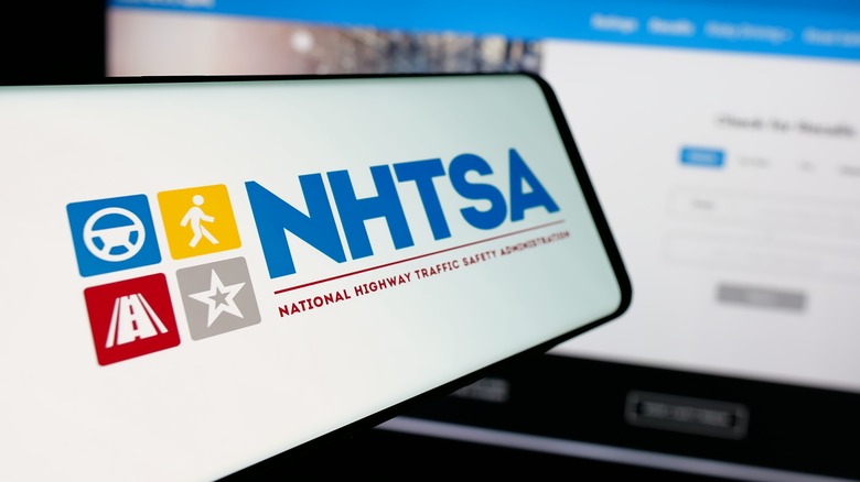 A cell phone displays the NHTSA logo