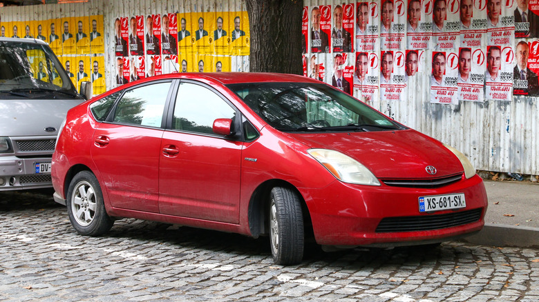 Front 3/4 view of a red Toyota Prius