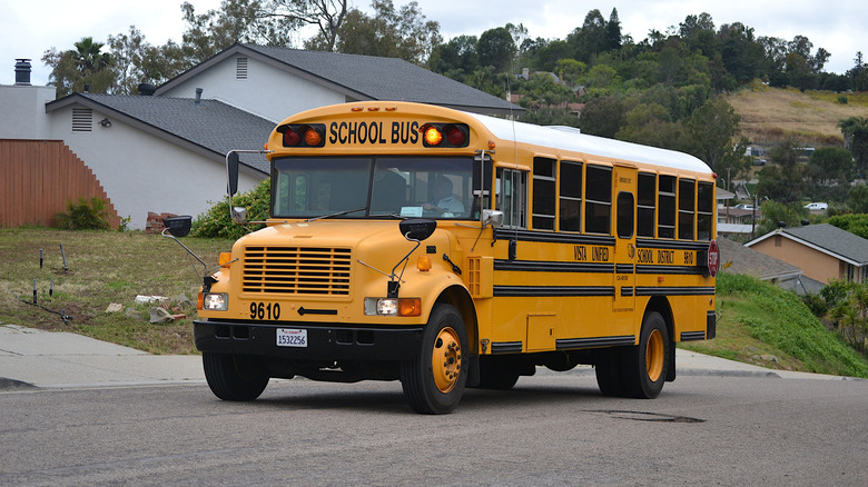 school bus driving past homes