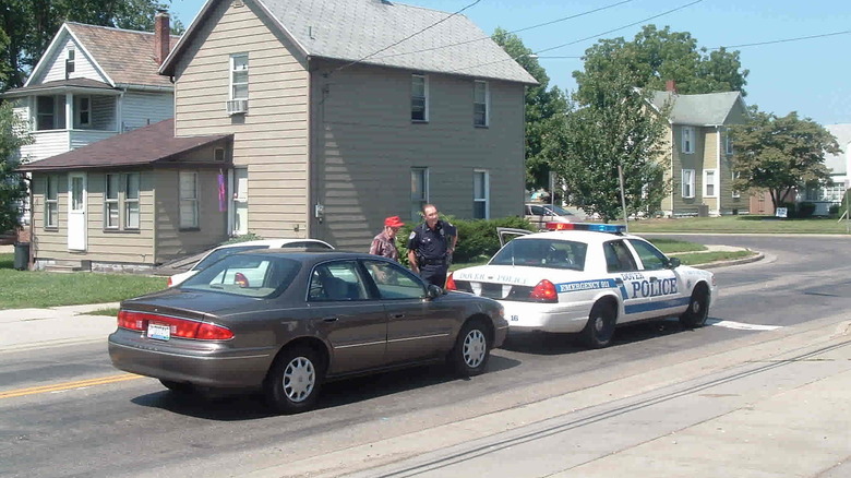 buick rear ended cop car with old man talking to cop