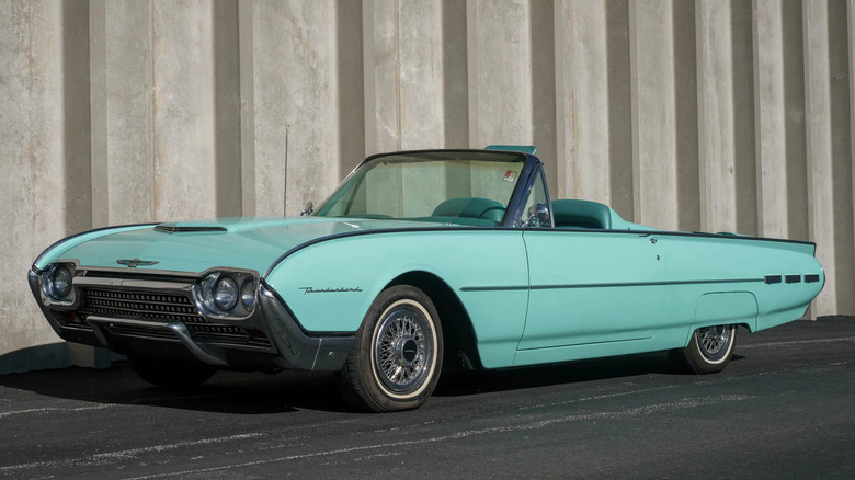 a mint green 62 thunderbird convertible top down